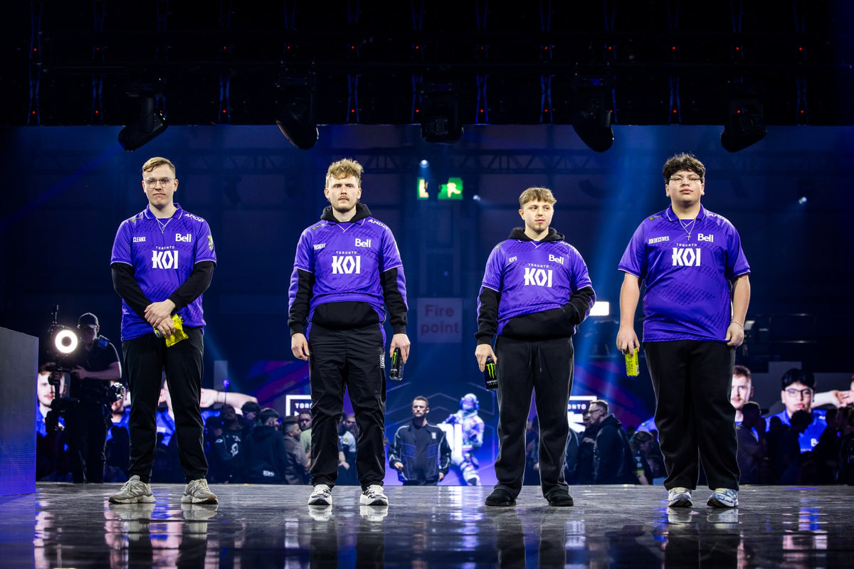 Toronto KOI on stage at DreamHack Birmingham, holding yellow PREF*RE pouches