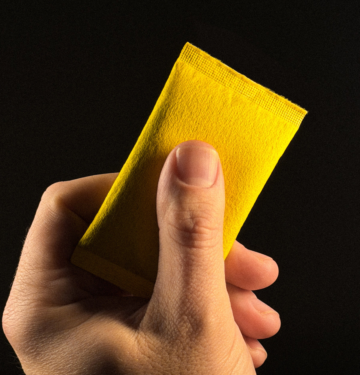 Hand holding an activated PREF*RE SOLO heat pouch