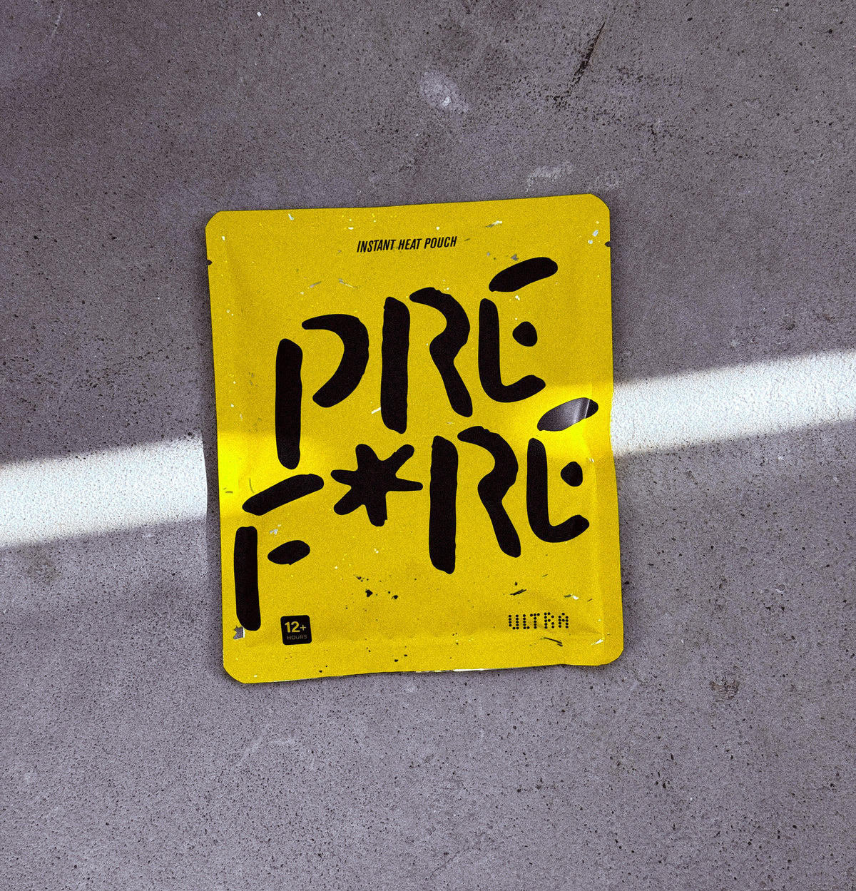 PREF*RE ULTRA pouch on concrete in a strip of sunlight