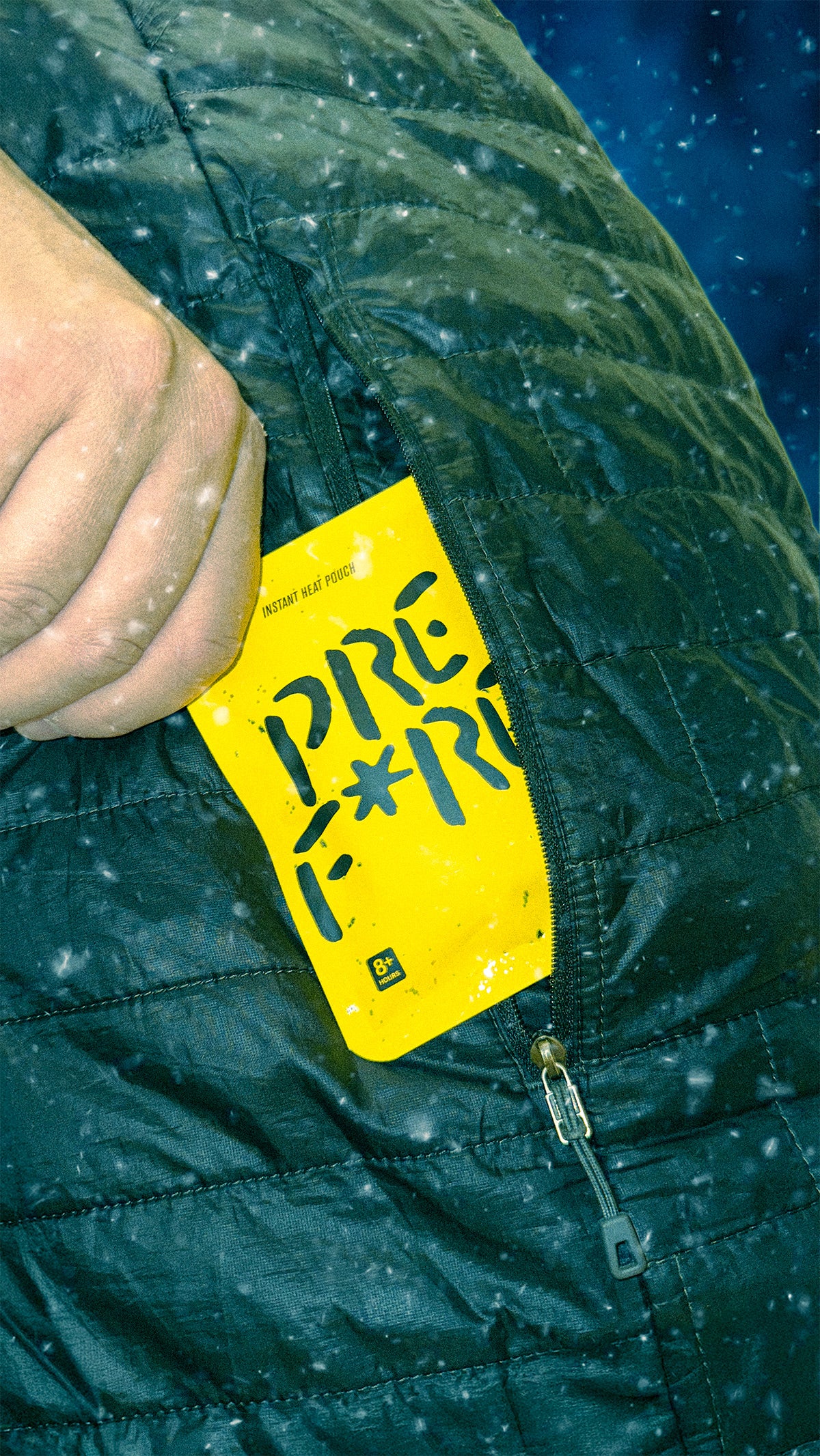 Yellow PREFIRE pouch in a jacket pocket in the snow